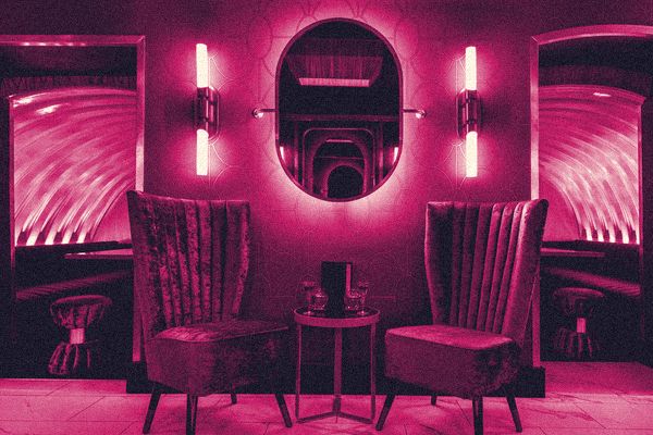 Velvet chairs and an arched mirror inside Disrepute, Kingly Court, Soho