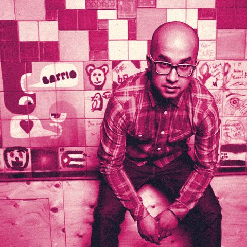 Ferdie Ahmed, founder of Barrio, in front of the hand-painted tile wall at Barrio