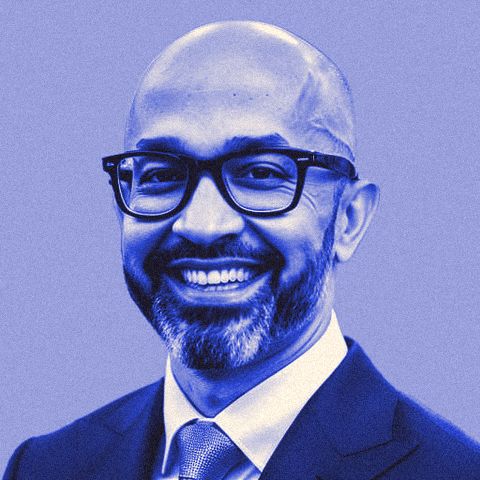 Ferdie Ahmed in a suit and tie, from his years in enterprise tech